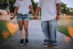 Close-up view of casual outfits and shoes during an outdoor photoshoot.