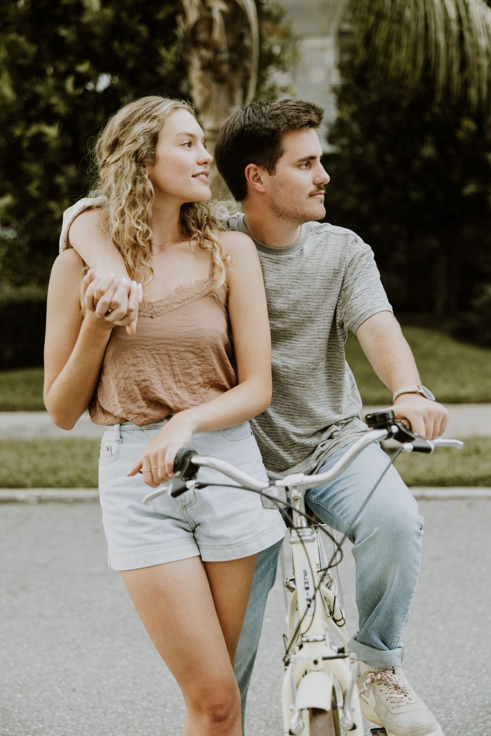 Golden hour couple photos with bike on Palm Beach Island at Lake Drive park and Town Docks captured by Lindsay McDow Photography