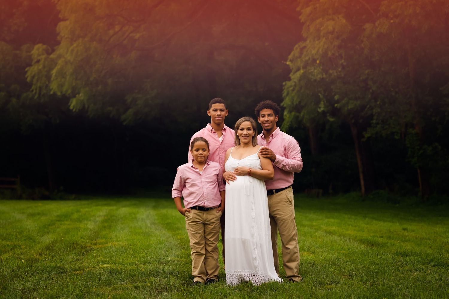 Maternity session outdoors mom and her sons