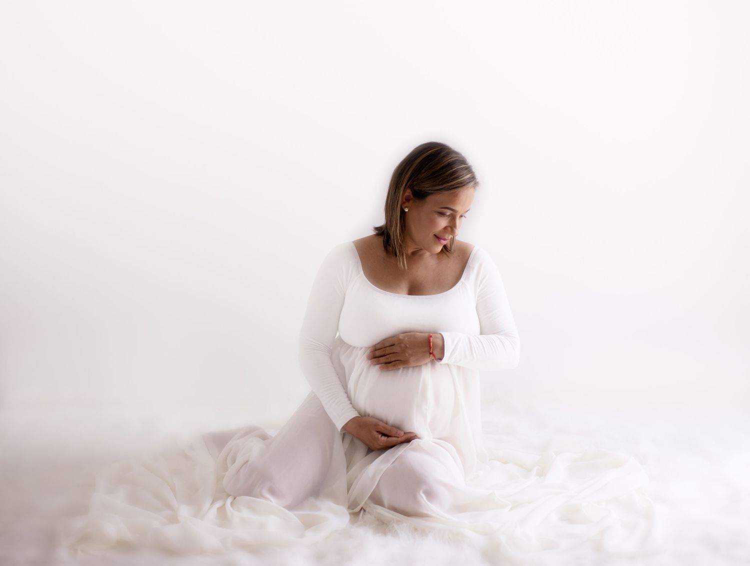 all white studio maternity session with mom and white dress