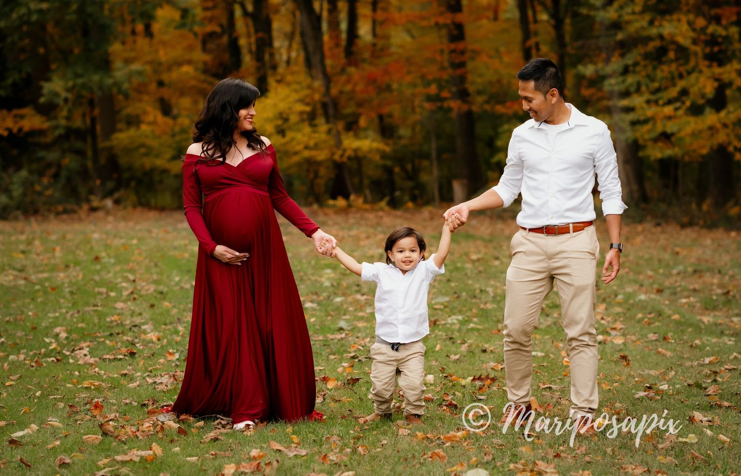outdoor maternity in red dress fall family son and husband meadow