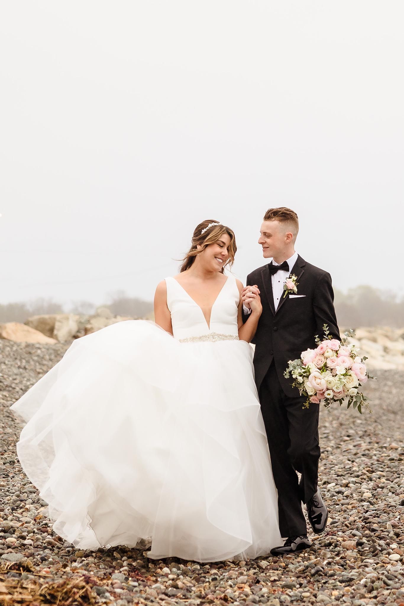 The bride and groom share a romantic moment on the beach at the Oceanview of Nahant.