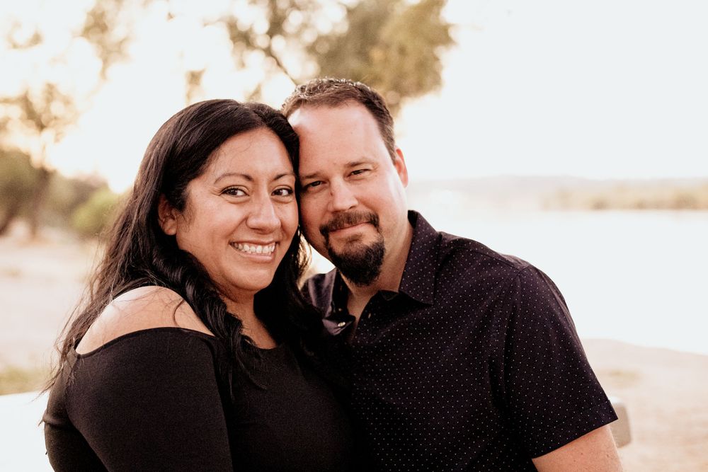 Couple sharing intimate moments during sunset photoshoot.