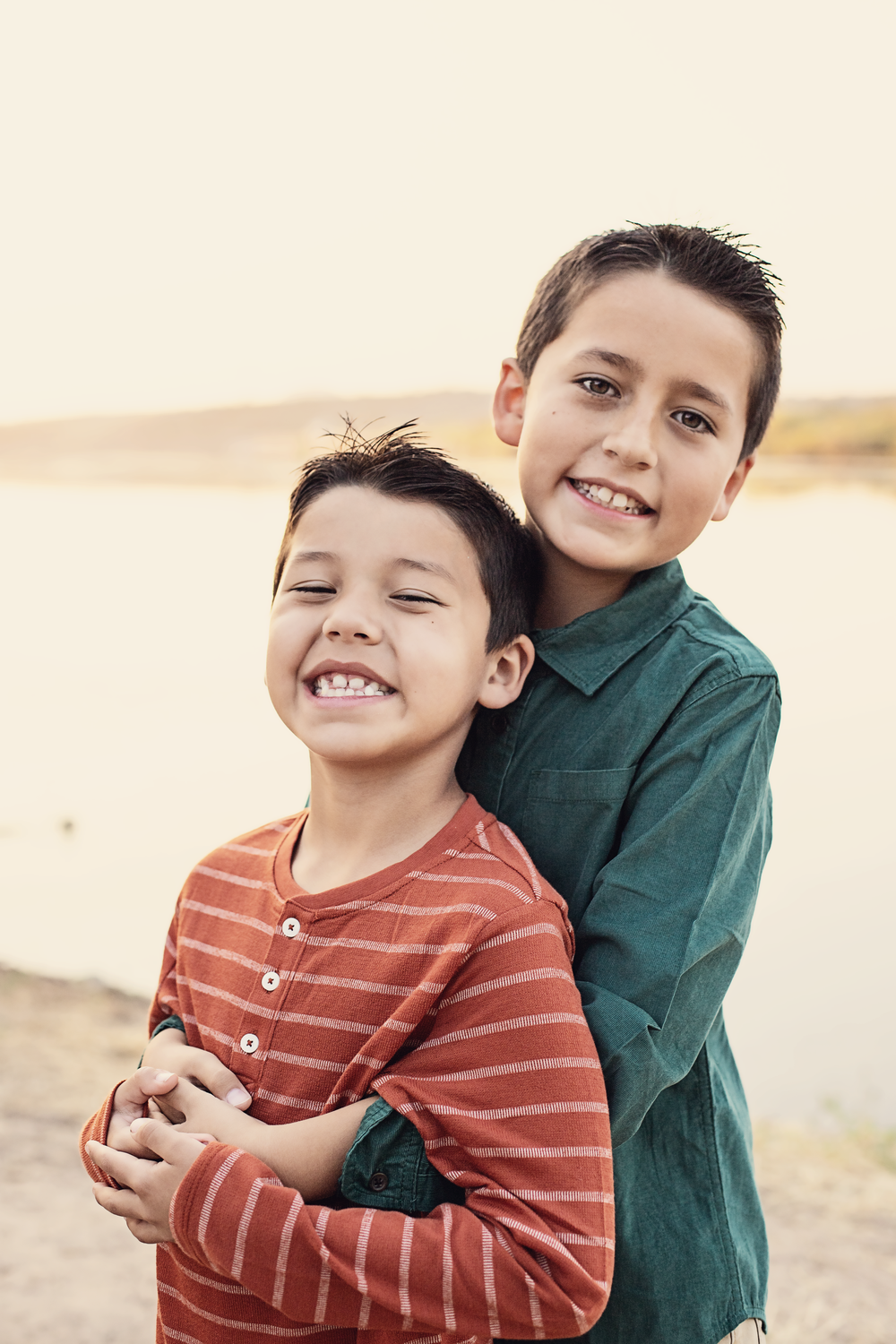 Playful family portrait series showing embraces and laughter outdoors.