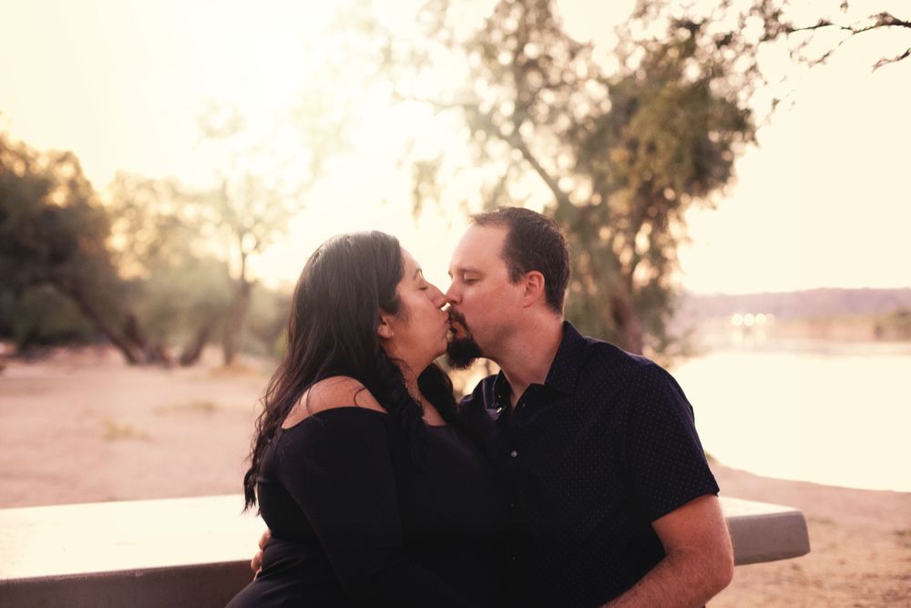 Family members share tender moments together during golden hour in a desert setting.