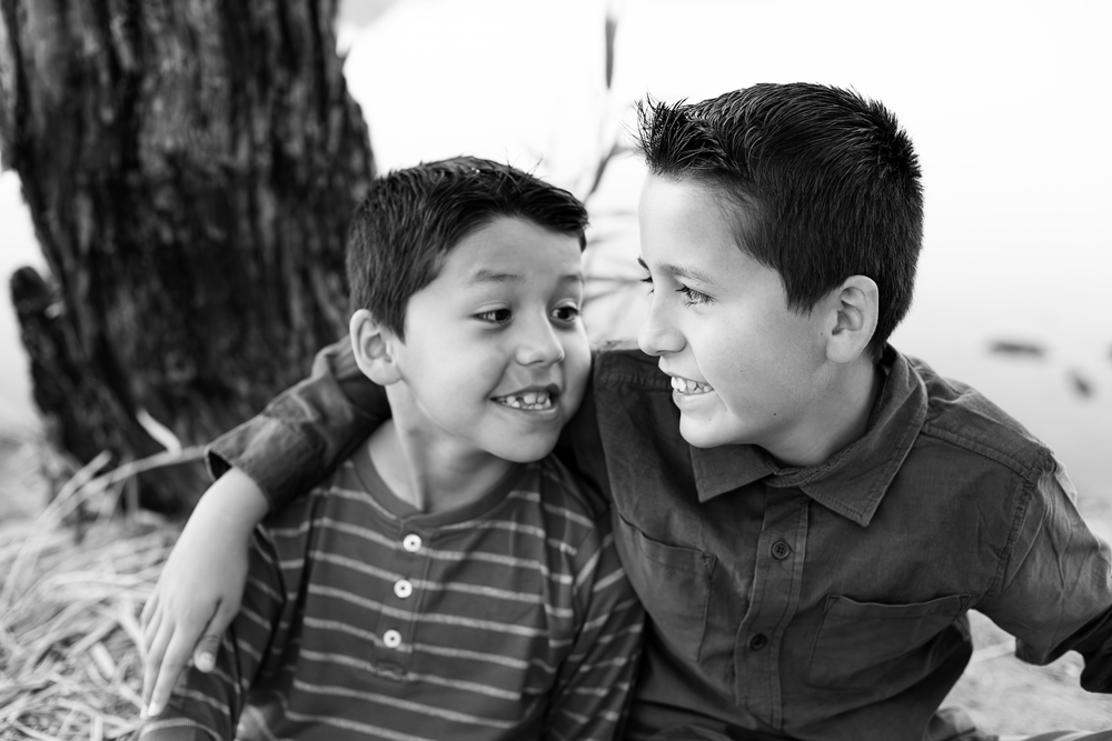 Black and white close-up series of family members interacting playfully together.