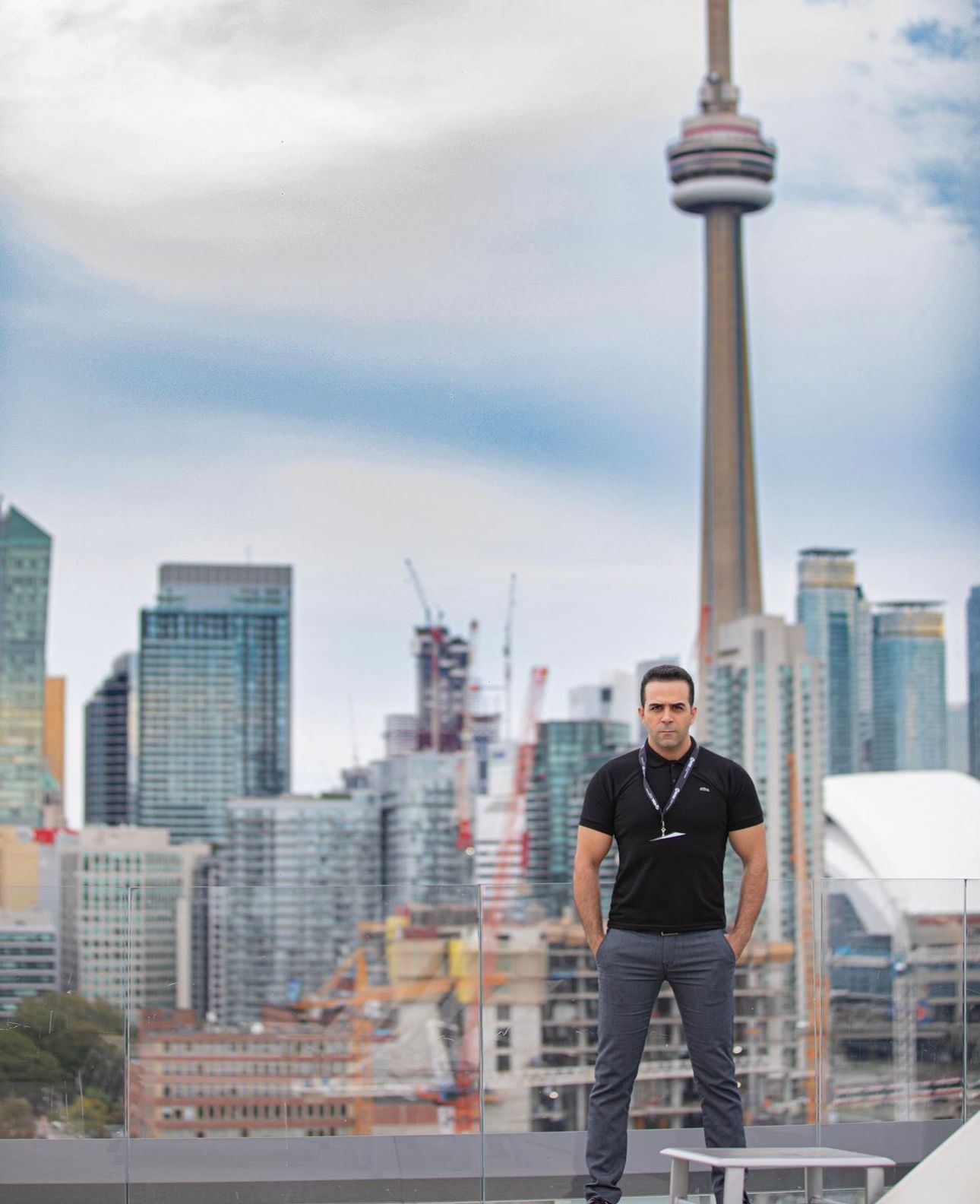 Toronto skyline view featuring the CN Tower and downtown buildings on a cloudy day.