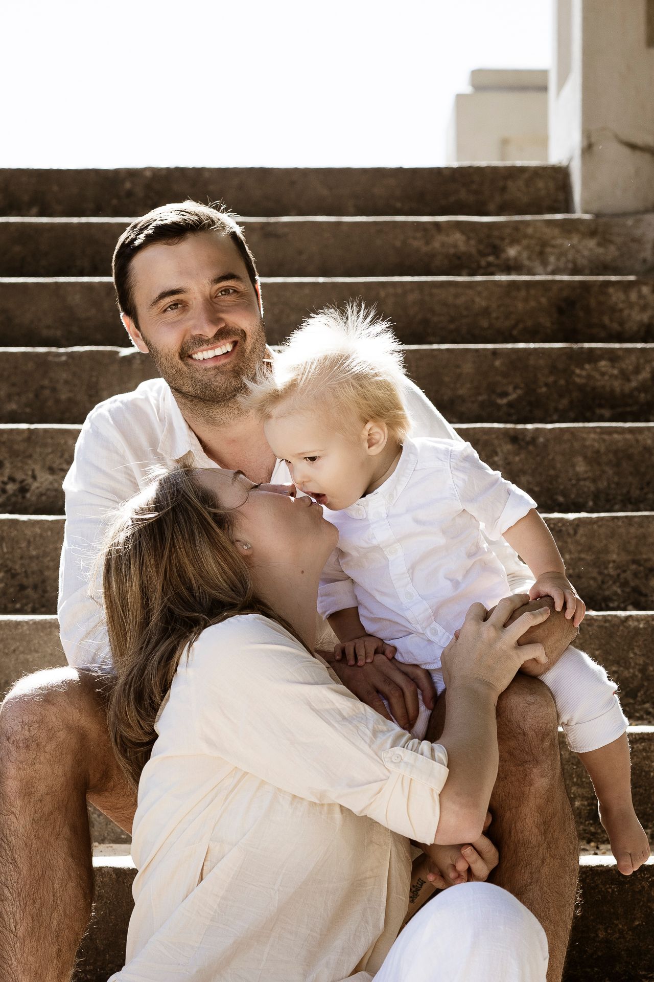 Mum kissing her baby during a heartfelt family photo session in St Ives
