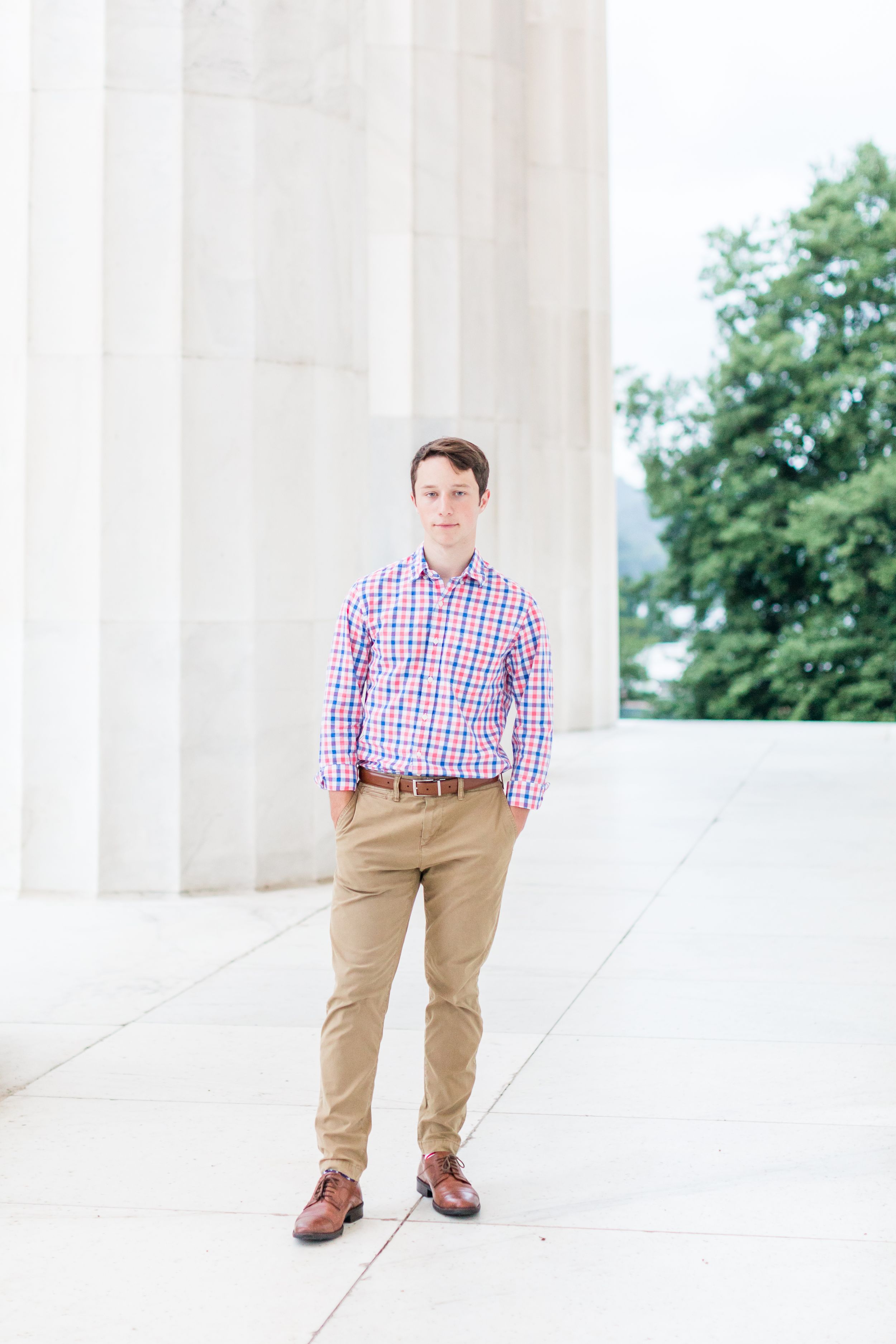 Senior boy standing with hands in pockets at Lincoln Memorial columns