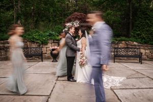 Artistic motion blur captures wedding ceremony moments in an outdoor garden setting.