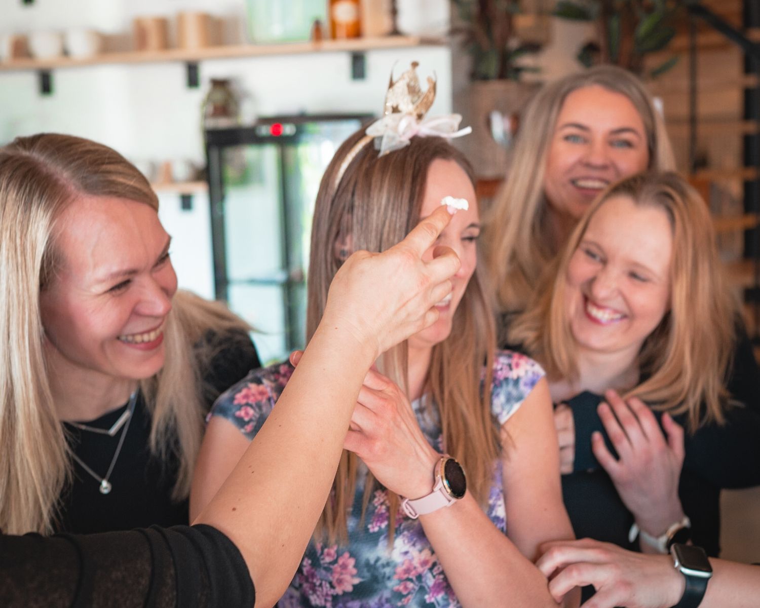 Friends share a joyful moment of laughter together at a cafe.