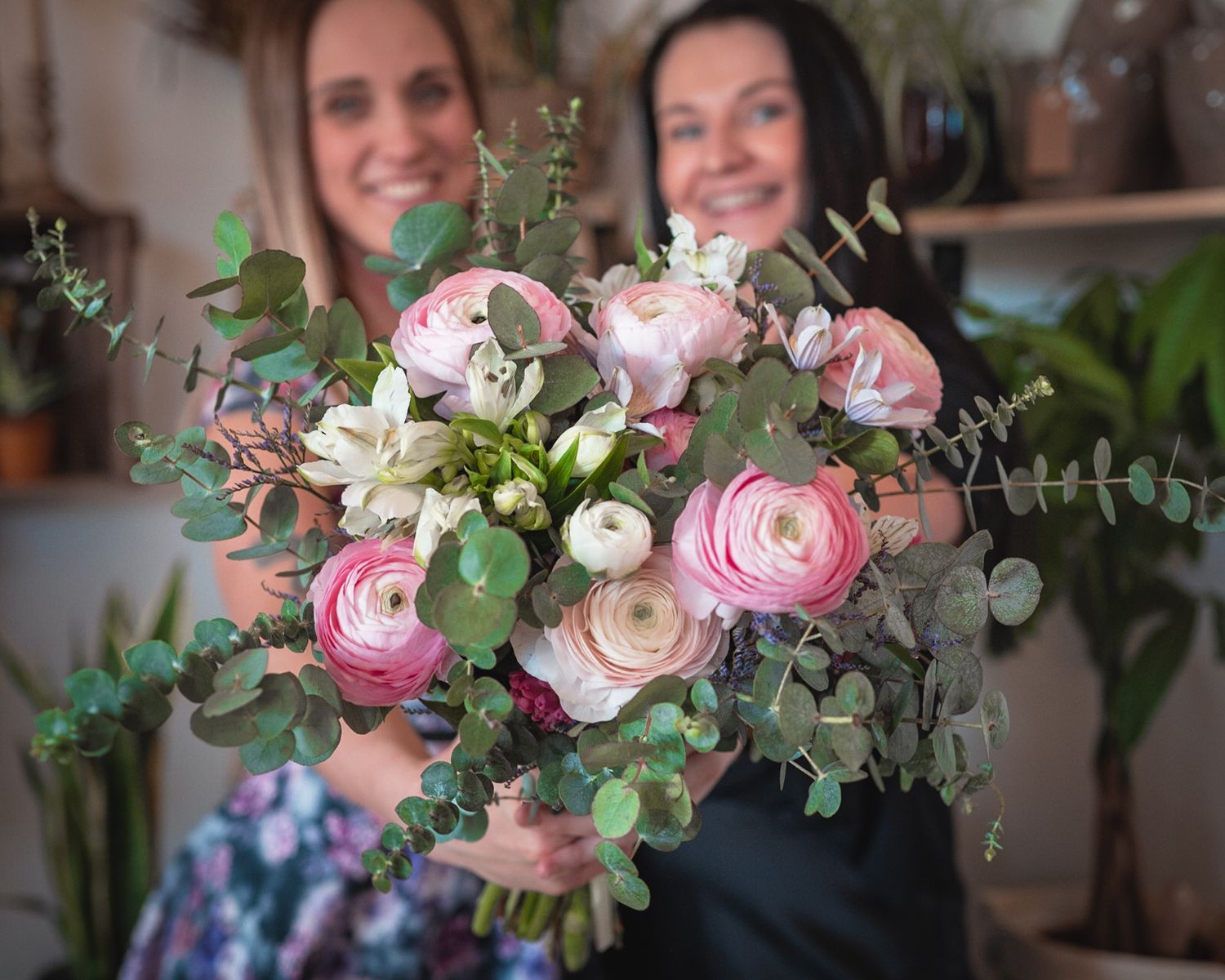 A stunning bouquet of pink roses and eucalyptus leaves arranged in vintage style.