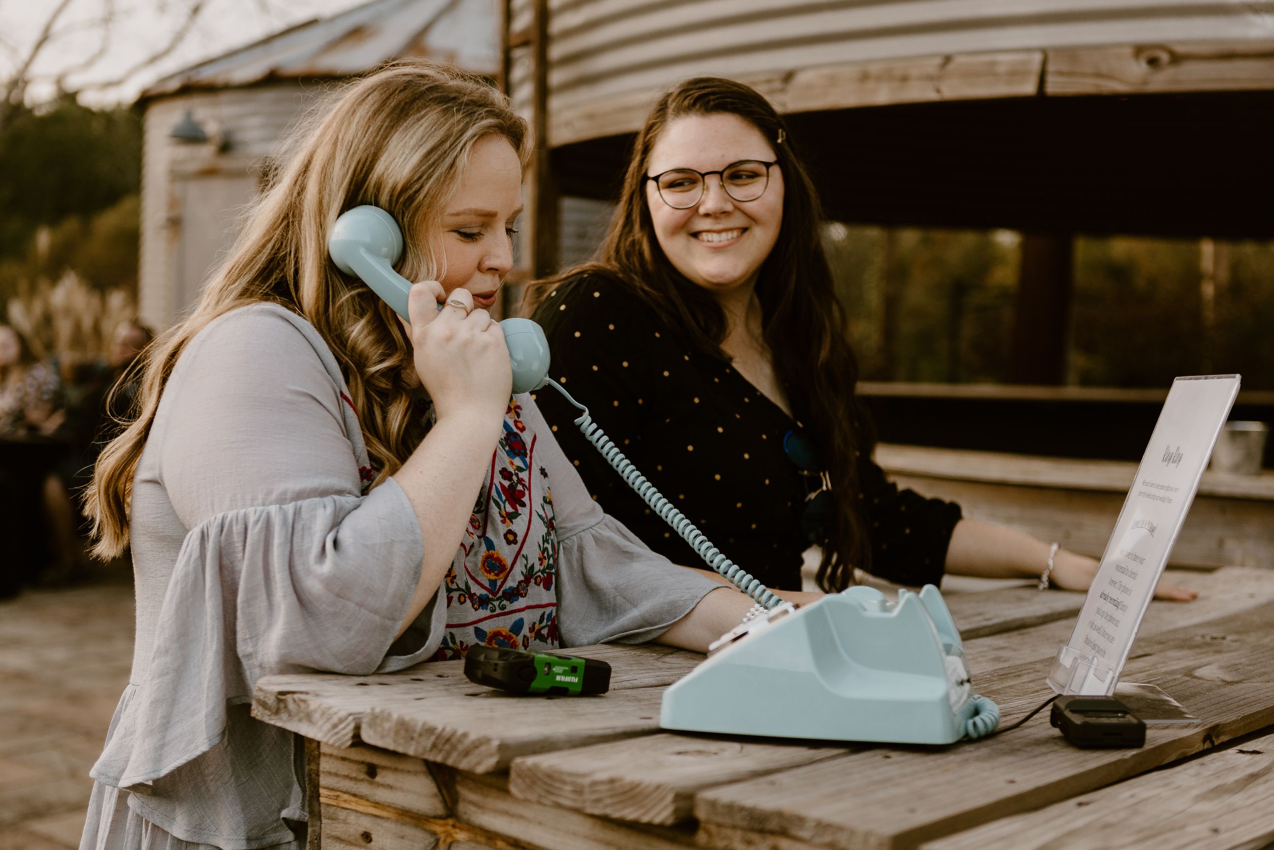 Woman holding Blue rotary phone audio voicemail wedding guestbook in Mobile, Alabama
