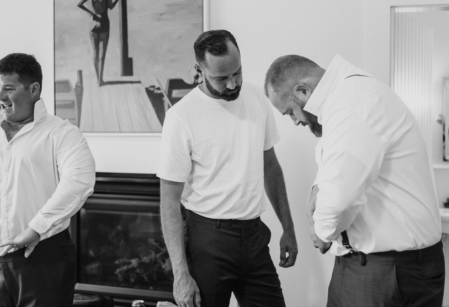 Group of people in white shirts gathered indoors for a casual occasion.