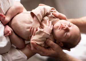 Scrunched up newborn photographed in natural window light