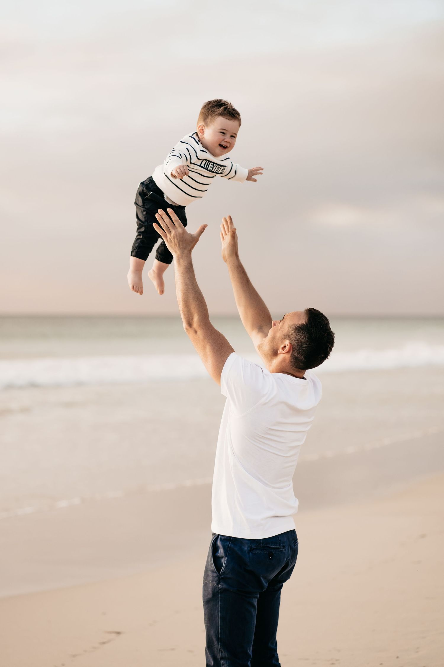 A sequence of joyful moments between parent and child playing at the beach during sunset.