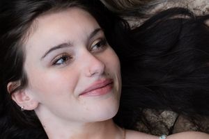 Close-up portrait series with dramatic lighting against a dark stone background.