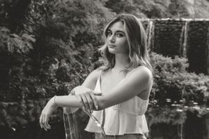 Black and white portraits captured in a natural outdoor setting with dramatic lighting.