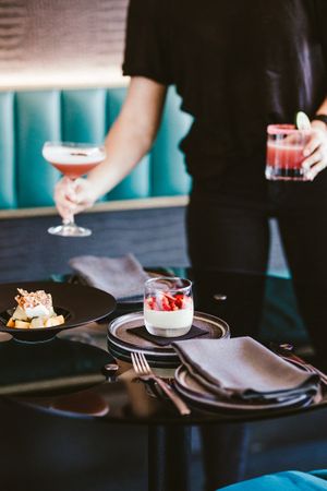 Place settings and glassware arranged elegantly on a dark table.