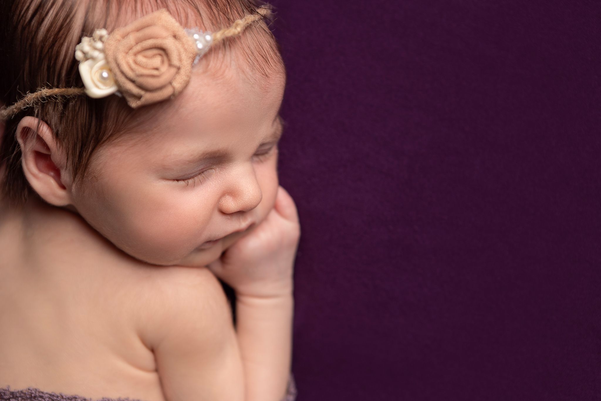 Sleeping baby girl with flower headband