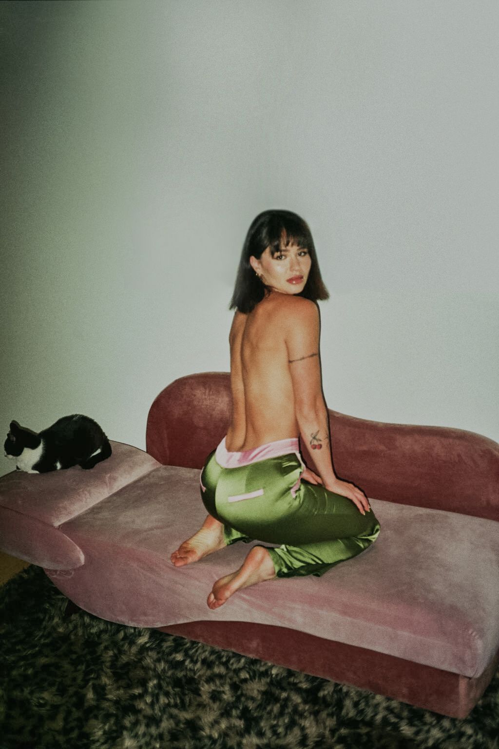 35mm film fashion portrait of woman in her home dressed in chartreuse pants