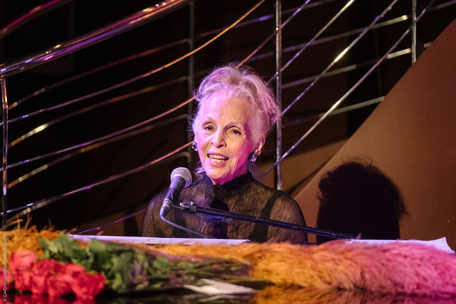 Older woman in a black dress performing at The Pheasantry In London.