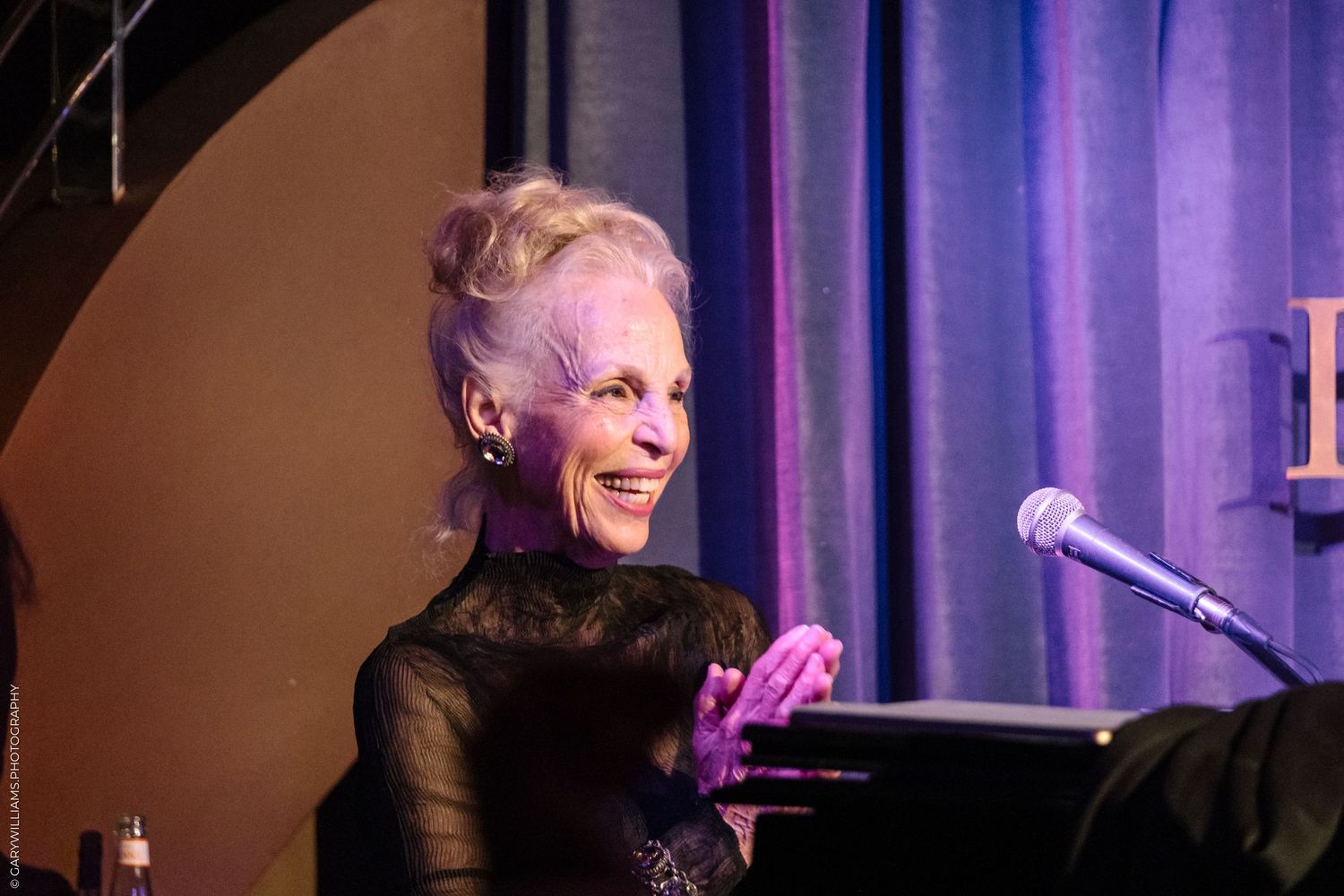 Older woman in a black dress performing at The Pheasantry In London.