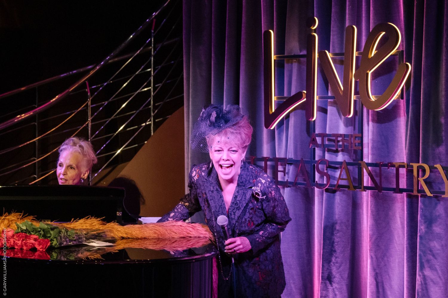 KT Sullivan on stage laughing at the Pheasantry, London.
