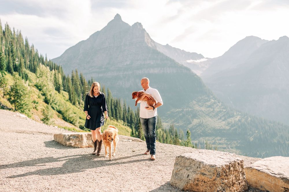couple walking with their dogs at big bend in glacier national park
