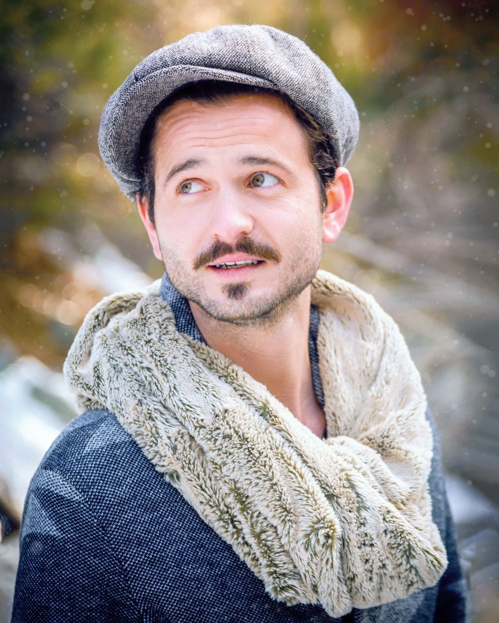 Male model in winter fashion posing in Big Bear with snow on the ground.