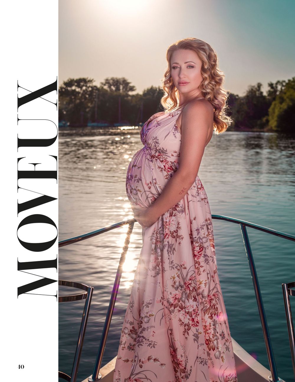 Elegant maternity photos on boat deck featuring flowing pink floral dress.