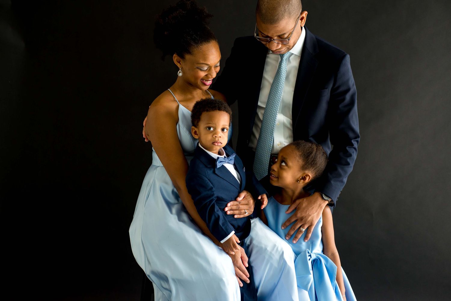 family taking pictures together in a natural light studio houston texas