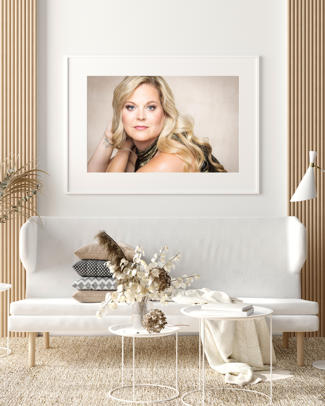 Living room setting with large print of woman with blonde hair above the couch