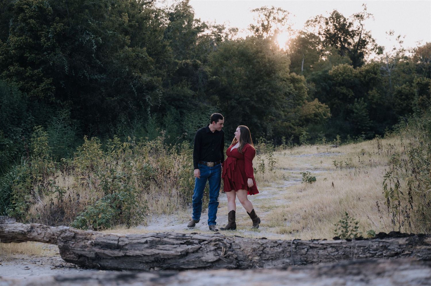A couple explores rocky terrain together during an outdoor photoshoot.