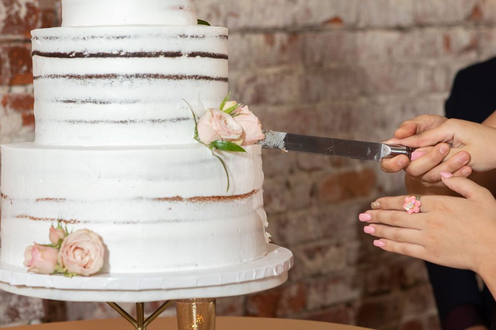 Elegant ballroom dance scene with gold accents and exposed brick wall.