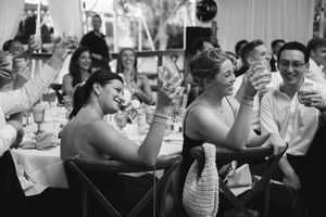 A sequence of black and white candid photos showing people laughing and enjoying themselves at a social gathering.