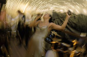 Blurred motion shots of people dancing at a nightclub or party with atmospheric lighting effects.
