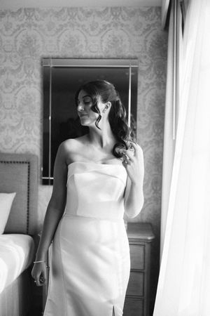 A series of black and white photographs showing someone wrapped in a white towel in a bathroom interior.