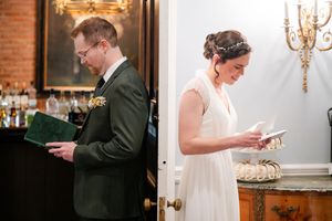 Bride and groom reading private vows separately before wedding ceremony in elegant venue.
