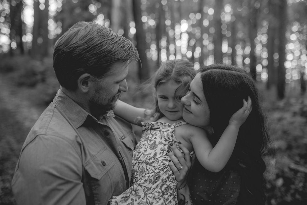 Sweet moment of a little girl hugging her mom in the serene Mark Twain National Forest Pines, surrounded by nature's beauty. Missouri Photog