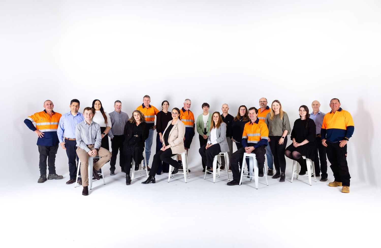 Large group of diverse business professionals standing together against white background.