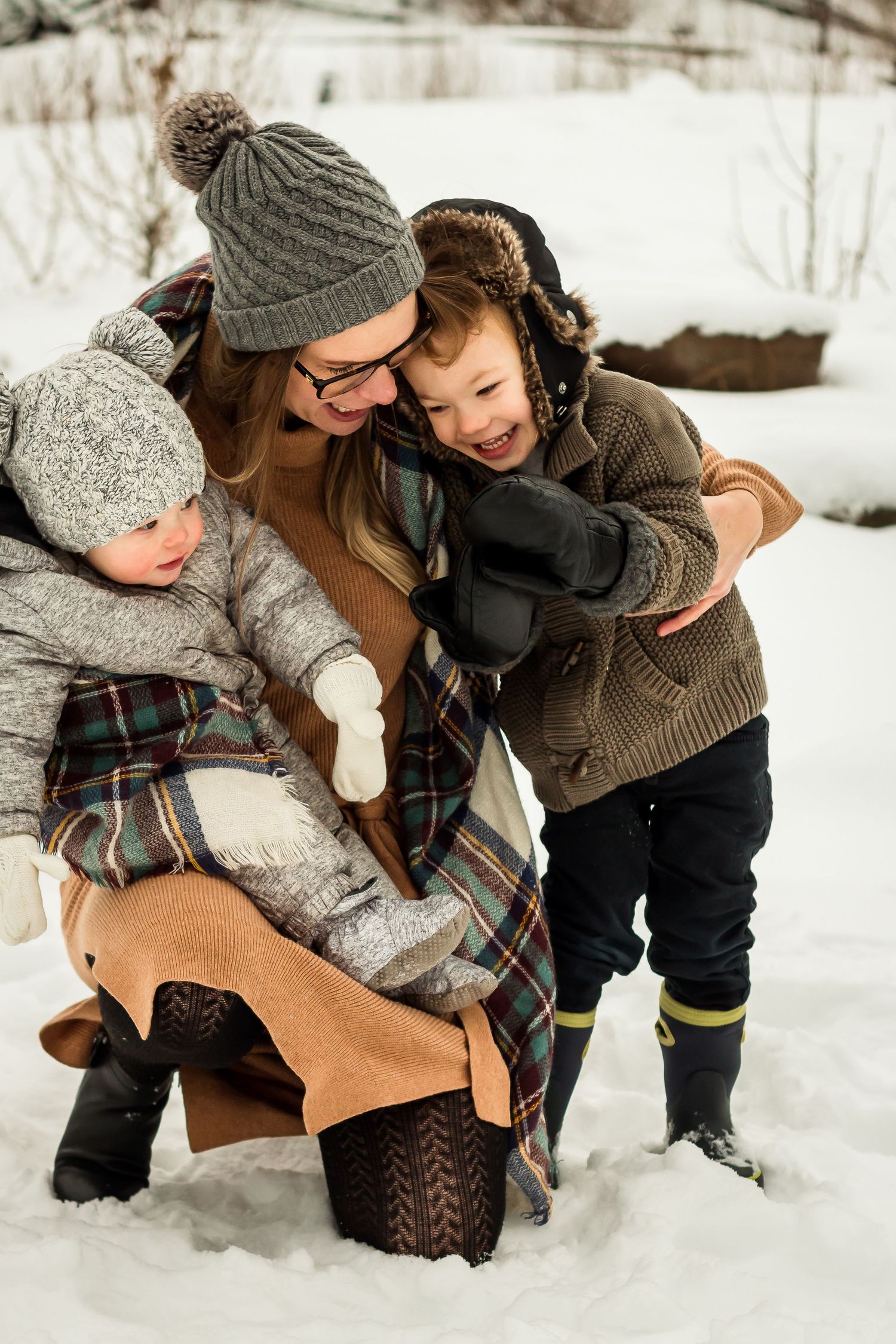 Cute motherhood moment during winter family photos in Bragg Creek by Love & Sunshine Photography
