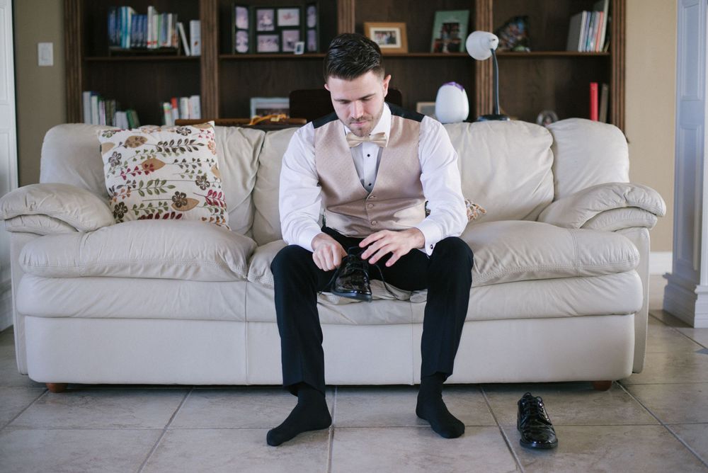 groom putting on the shoes. wedding day. Progreso Texas. wedding photographer