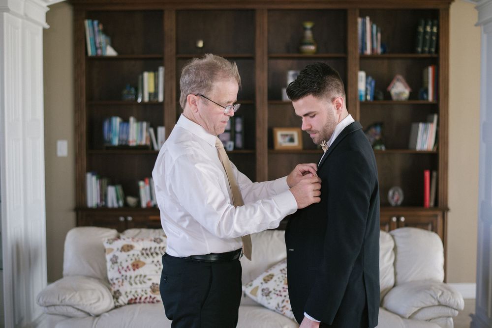father helping his son getting ready. wedding day. Progreso Texas. wedding photographer