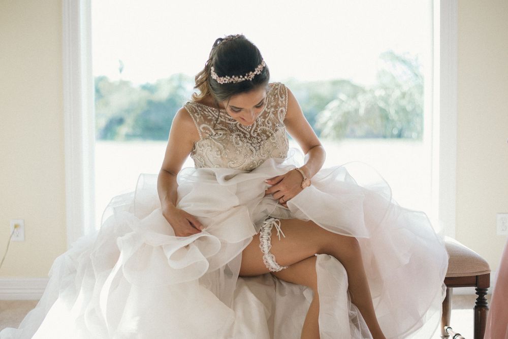bride showing garter. wedding day. Progreso Texas. wedding photographer