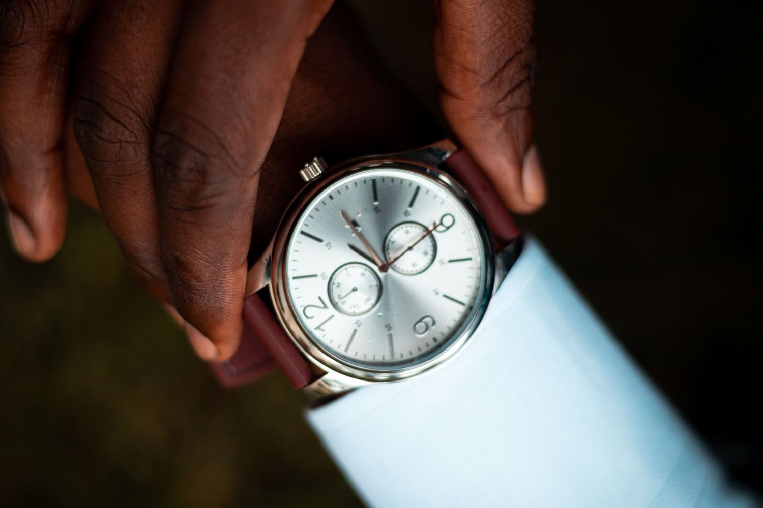 Watch detail, close up, silver watch, red belt, corporate shoot.