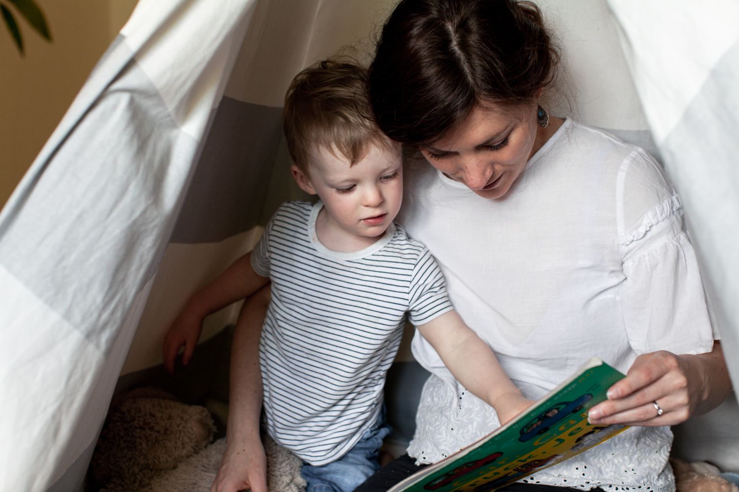 Close up of mother and son reading book