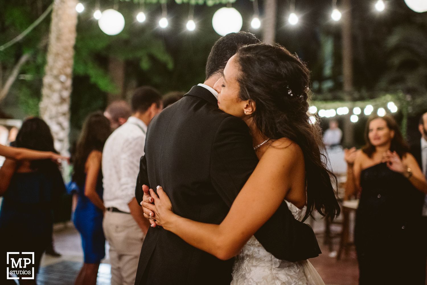 Intimate slow dance moment captured during an evening wedding reception.