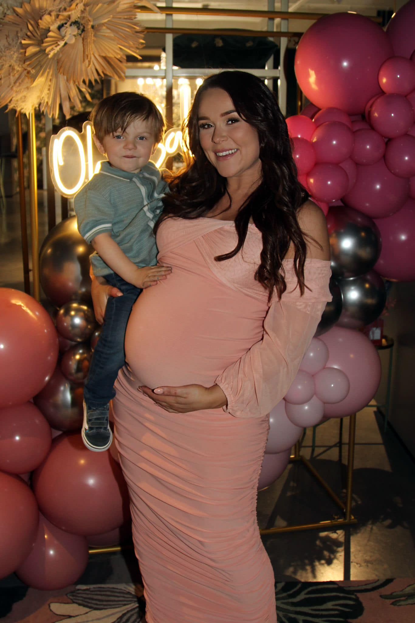 Baby shower celebration with pink decor and balloons creating a warm atmosphere.