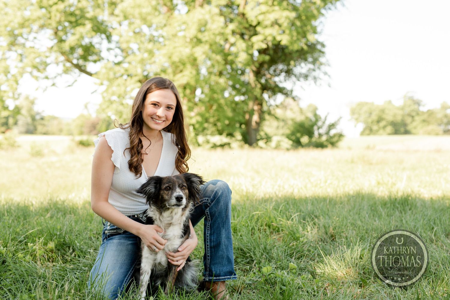 Casual outdoor portrait with rescue dog in sunny field.